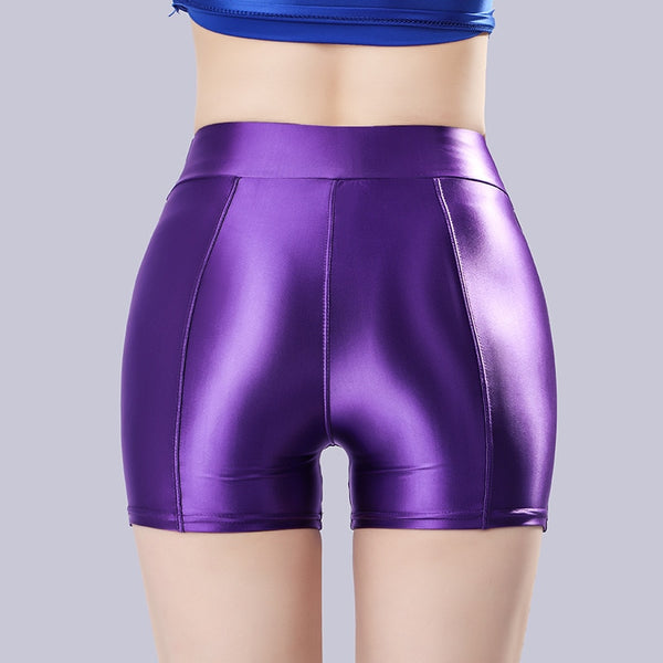 Back view of lady wearing a purple color shorts featuring a wide waistband for all-day comfort and a seductive glossy fabric.