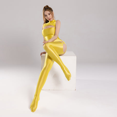 front view of lady wearing yellow wet-look shiny dress featuring a high neckline, bust cut-out, back zipper closure, and matching gartered thigh high stockings.