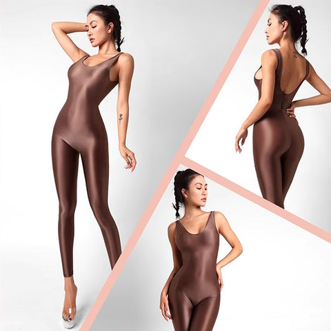 A lady posing in a brown catsuit featuring spaghetti straps, a scoop neckline, a low back cut, back zipper closure, and shiny wet look fabric.