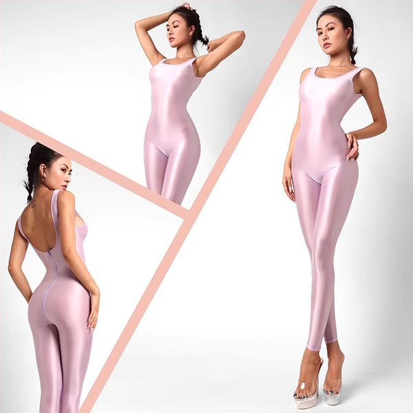 A lady posing in a lavender catsuit featuring spaghetti straps, a scoop neckline, a low back cut, back zipper closure, and shiny wet look fabric.