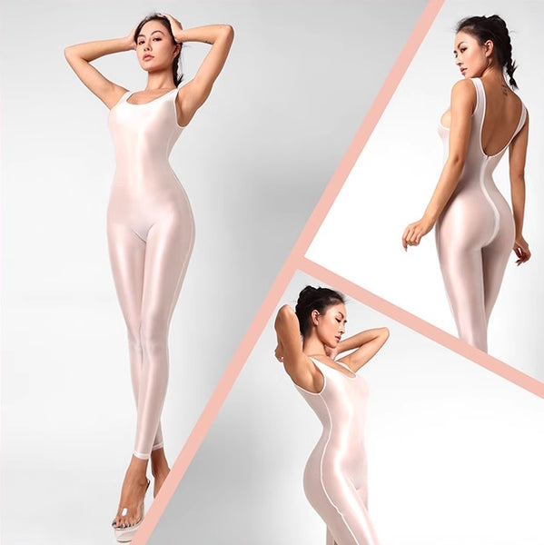A lady posing in a white catsuit featuring spaghetti straps, a scoop neckline, a low back cut, back zipper closure, and shiny wet look fabric.