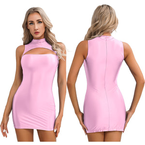 A woman posing in a pink sleeveless glossy mini party dress with a front bust cut out, high neckline and back zipper closure.