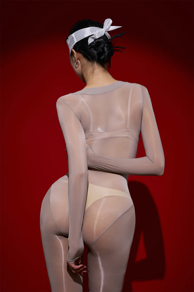 Person wearing a sheer outfit with a red background