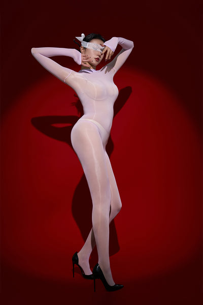 Person wearing a lavender bodystocking against a red background