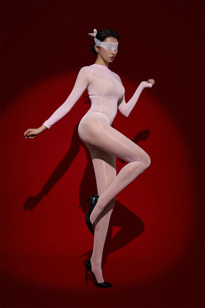 Woman wearing a sheer outfit with black high heels on a red background