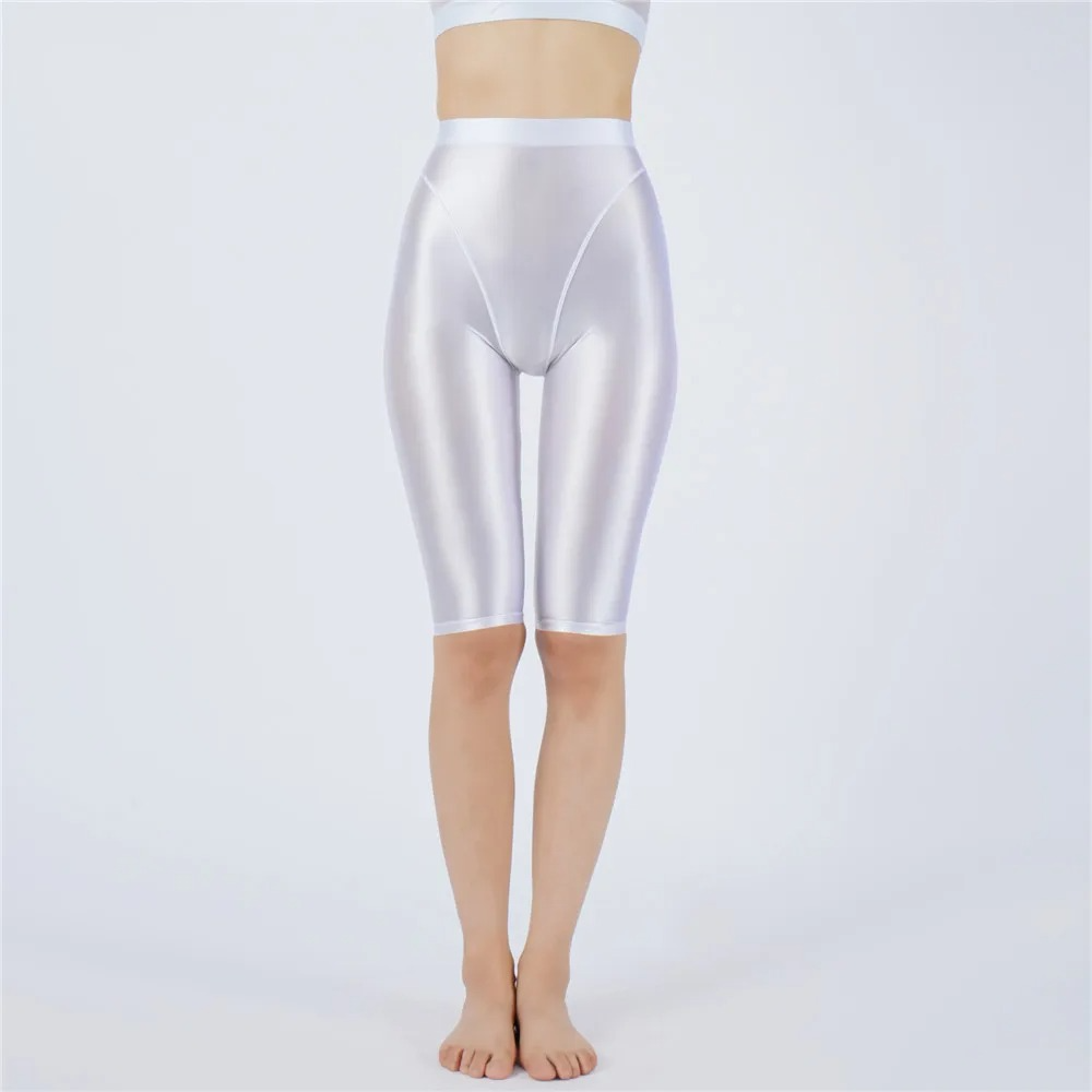 Shiny white shorts worn by a person on a light gray background