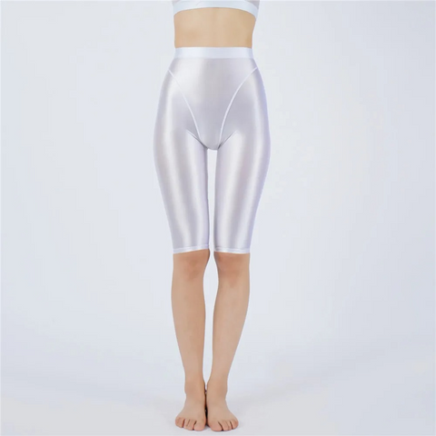 Shiny white shorts worn by a person on a light gray background