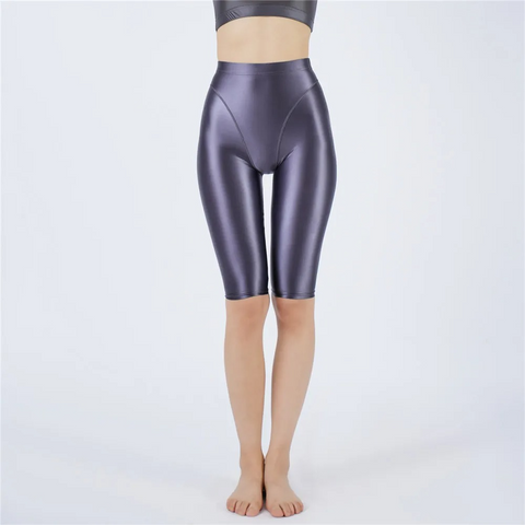 Shiny gray shorts worn by a person on a white background