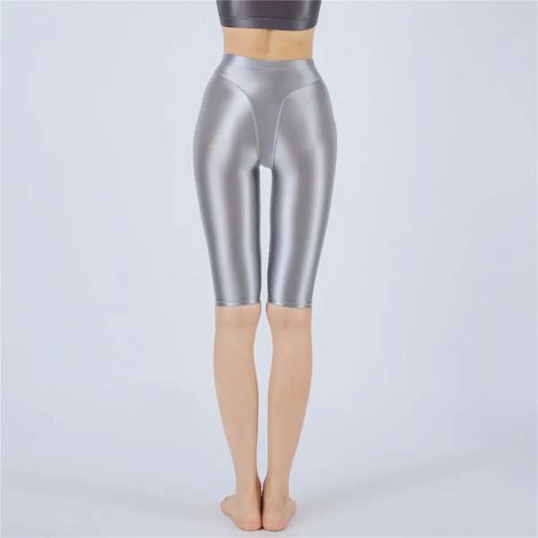 Silver shorts worn by a person on a light gray background