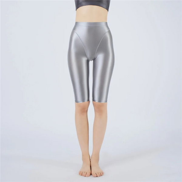 Silver metallic shorts worn by a person on a white background