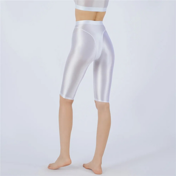 Shiny white shorts worn by a person on a light gray background
