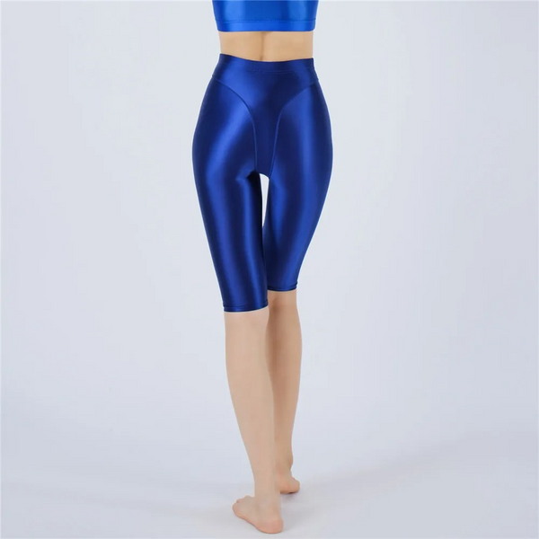 Shiny blue shorts worn by a person on a white background