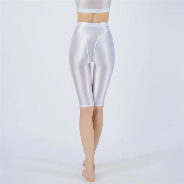 Shiny white shorts worn by a person on a light gray background