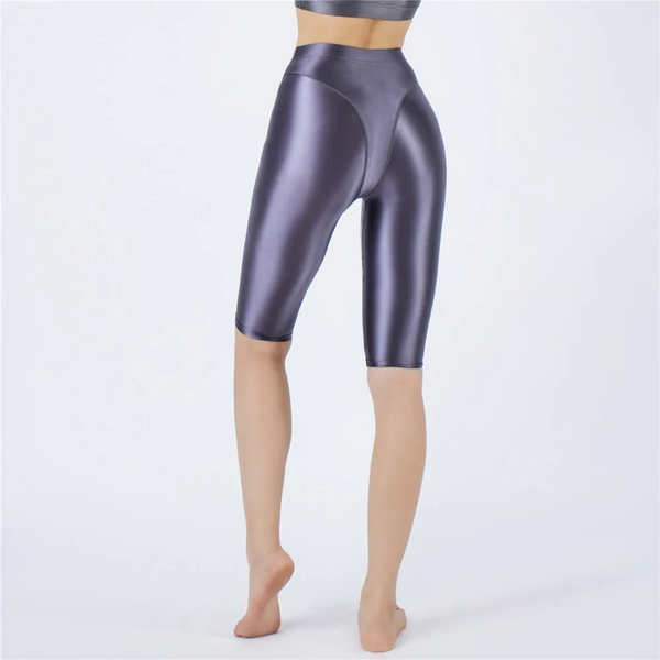 Shiny gray shorts worn by a person on a white background