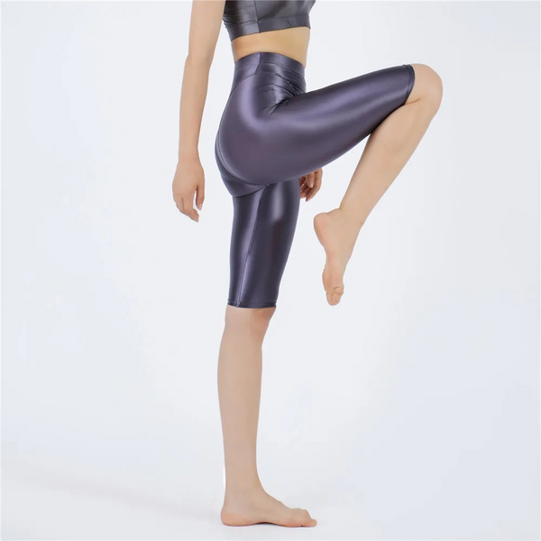 Shiny gray shorts worn by a person on a white background