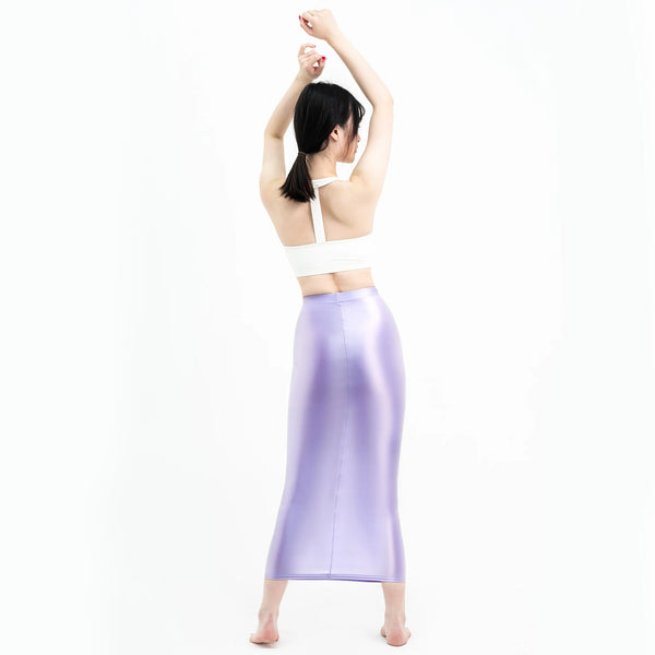 A woman posing in a lavender colored maxi skirt with elastic waistband.