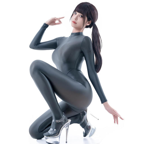 A woman posing in a dark gray glossy catsuit with high heels.