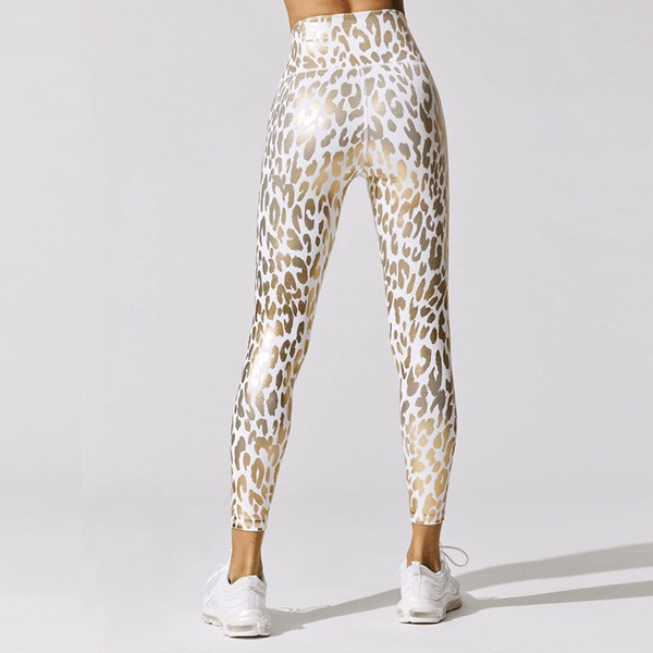 Back view of lady wearing white high waist leggings with gold shiny leopard prints and ankle length.