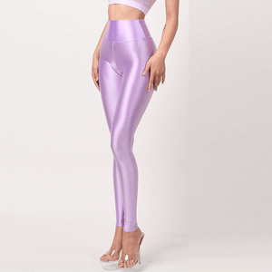 Front view of lady wearing lavender wet look high waist legging with wide waistband.