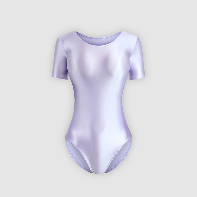 Front view of a lavender color wet look leotard featuring a scoop neckline, short sleeves and a cheeky cut back.