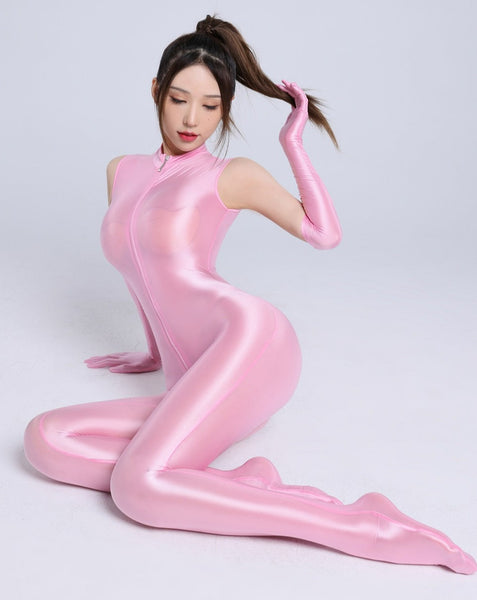 Front view of lady wearing pink wet look catsuit featuring a front to crotch zipper closure, matching gloves and a seductive shiny fabric.