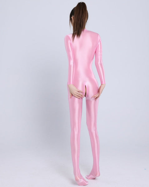 Back view of lady wearing a pink color glossy wet look full-body catsuit with front-to-crotch zipper closure, long sleeves, and closed feet.