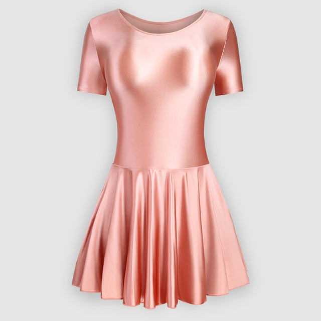 Front view of coral leotard dress featuring a scoop neckline, a scoop back cut, short sleeves, and an attached skirt.