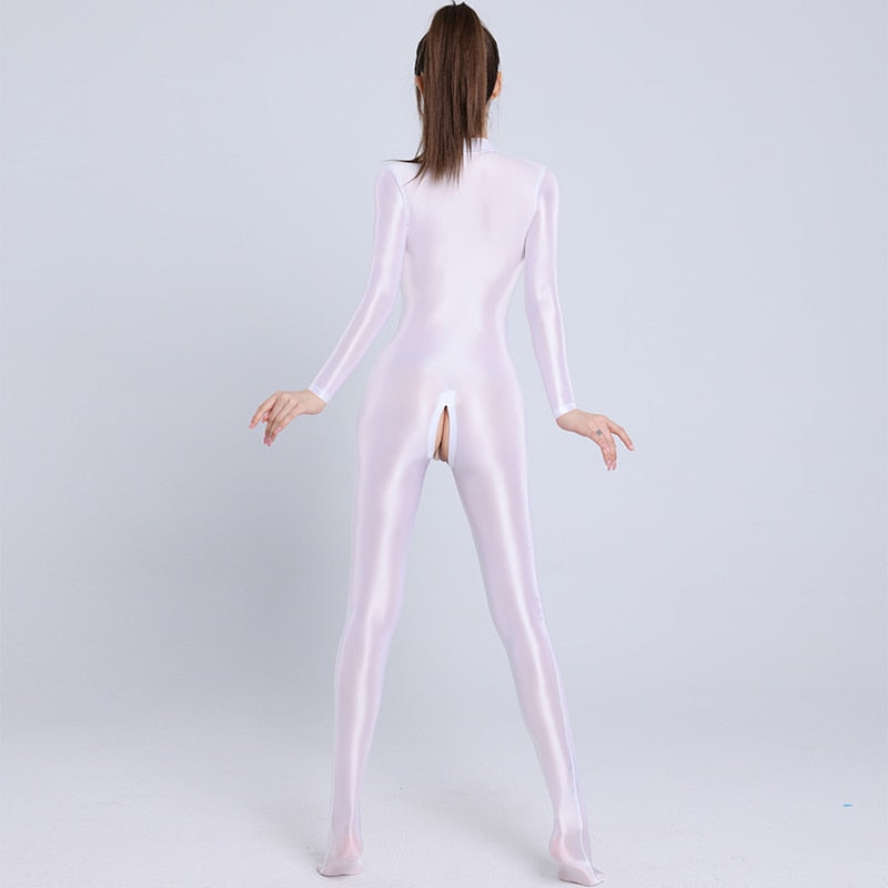Back view of lady wearing a white color glossy wet look full-body catsuit with front-to-crotch zipper closure, long sleeves, and closed feet.