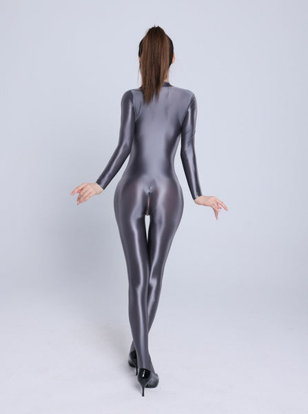 Back view of lady wearing a ash color glossy wet look full-body catsuit with front-to-crotch zipper closure, long sleeves, and closed feet with black high heels.