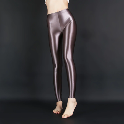 front view of lady wearing brown wet look shiny legging showing off her feet