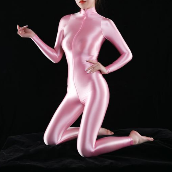 front view of lady wearing pink wet look shiny catsuit featuring long sleeves, turtle neck and front to back zipper closure showing off her feet