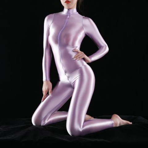 front view of lady wearing purple wet look shiny catsuit featuring long sleeves, turtle neck and front to back zipper closure showing off her feet