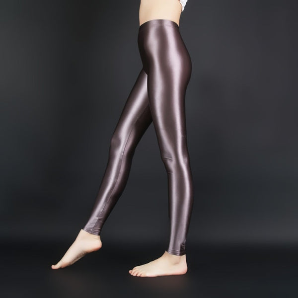 side view of lady wearing brown wet look shiny legging showing off her feet