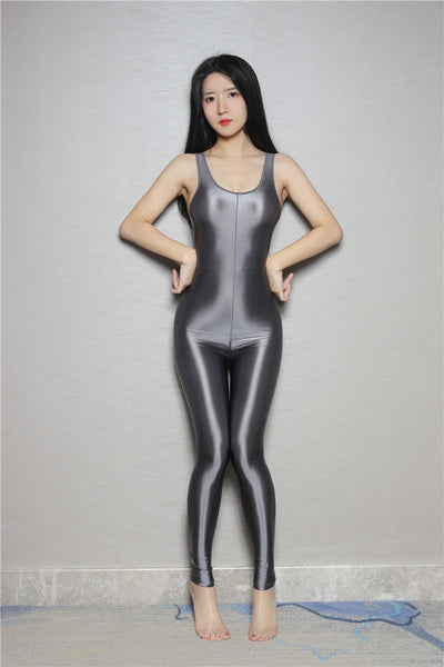 front view of lady wearing gray catsuit featuring thick shoulder straps, scoop neckline, shiny wet look fabric. 