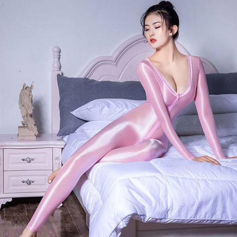 front view of lady wearing pink wet look shiny catsuit featuring scoop neckline, long sleeves, front to back zipper closure