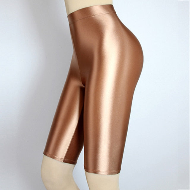 side view of lady wearing brown shiny wet look running shorts