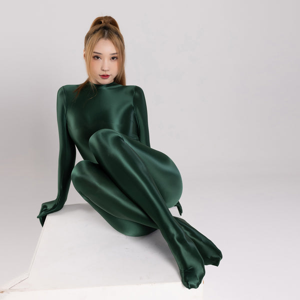 front view of lady wearing dark green color wet look catsuit featuring long sleeves, a high neckline, and a back zipper closure.