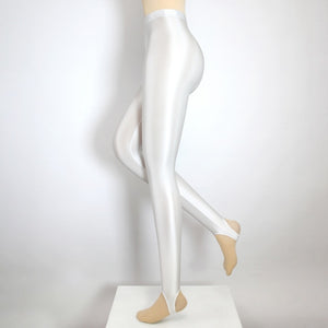 Side view of white shiny wet look stirrup legging.