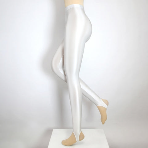 Side view of white shiny wet look stirrup legging.