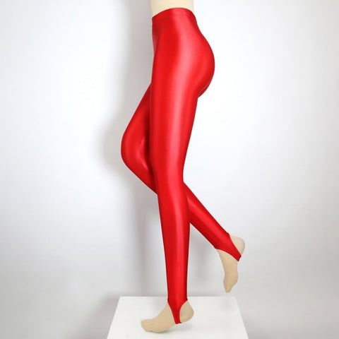Side view of red shiny wet look stirrup legging.