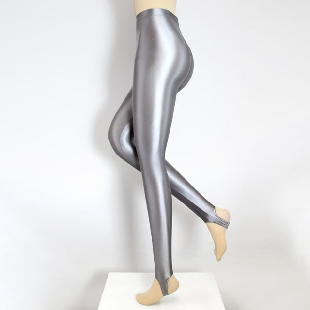 Side view of silver color shiny wet look stirrup legging.