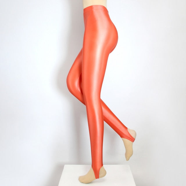 Side view of coral color shiny wet look legging.