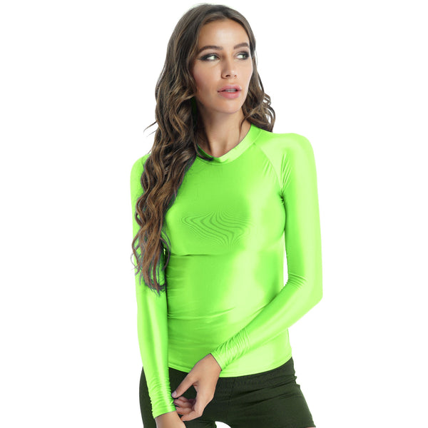 Front view of lady wearing shiny green spandex long sleeve shirt.