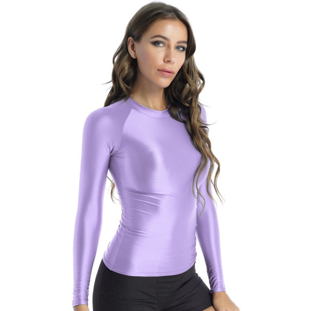 Front view of lady wearing shiny lavender spandex long sleeve shirt.