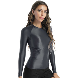 Front view of lady wearing dark gray shiny spandex long sleeve shirt