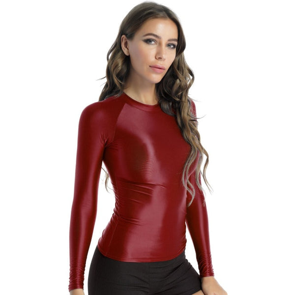 Front view of lady wearing shiny wine red spandex long sleeve shirt.
